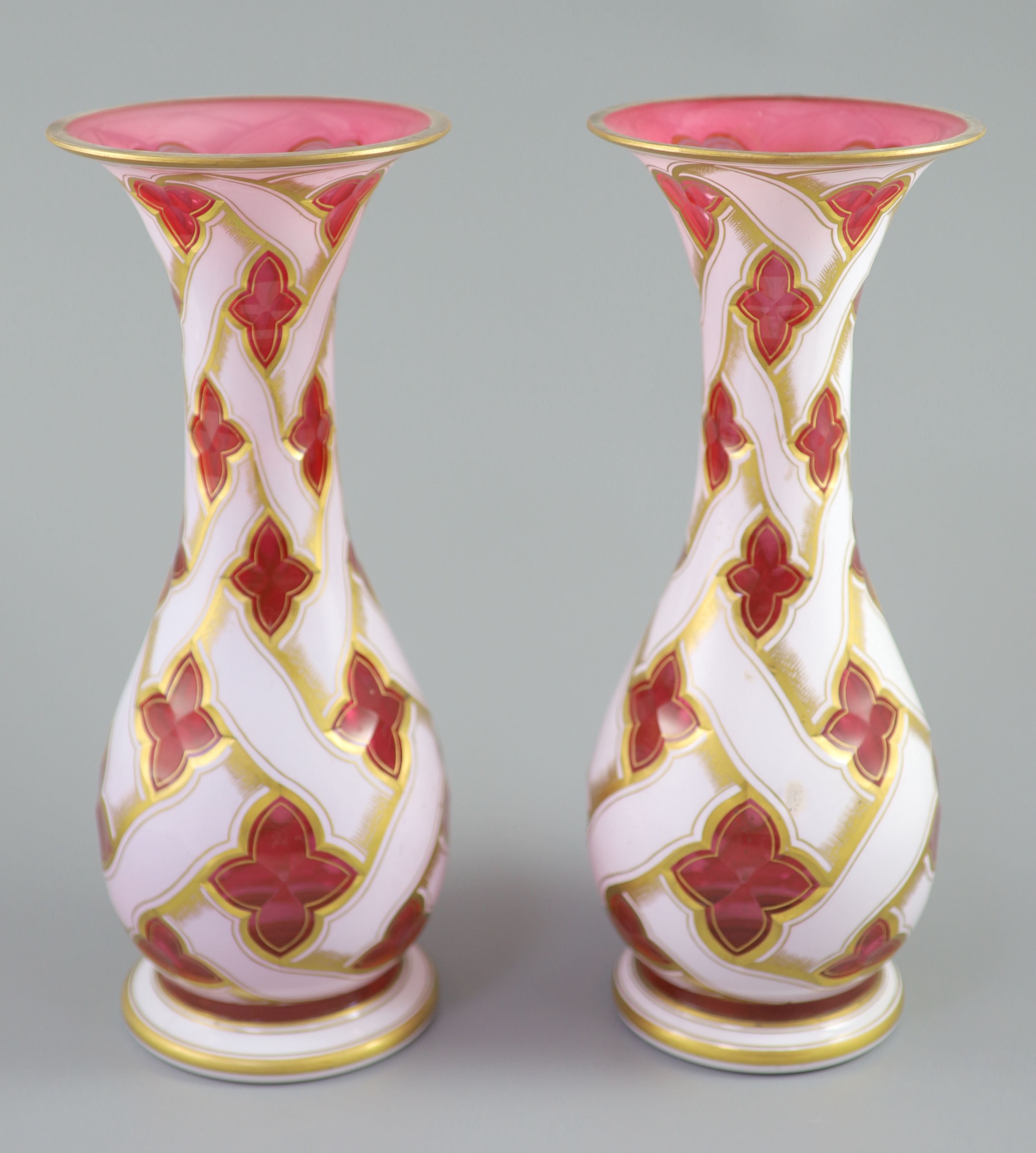 A pair of Bohemian white and ruby overlaid glass baluster vases, late 19th century, 34cm high